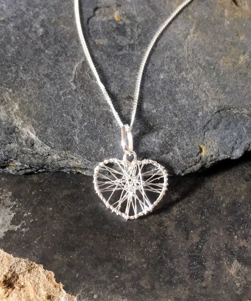 A sterling silver heart pendant necklace. The heart is wrapped in fine silver wire to create a beautiful piece of jewellery.